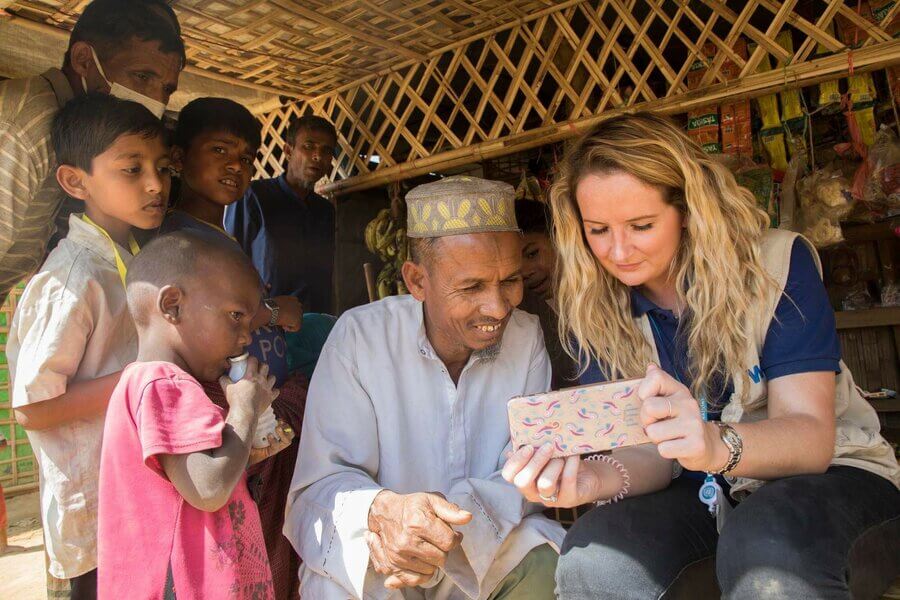 Officer Laura Philips with a Rohingya family in the Kutupalong megacamp during her visit