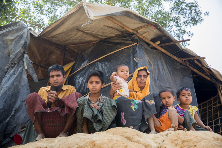 A Rohingya family, after arriving in the Kutupalong camps waiting with their hungry children for food support.