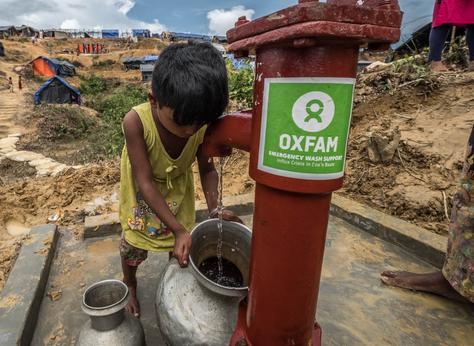 A Rohingya child collecting drinking water from a raised tube well- one of 166 deep water pumps installed by Oxfam, replacing the shallow water pumps.